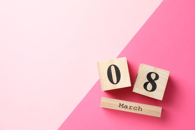 8 march wooden calendar on two tone background, space for text