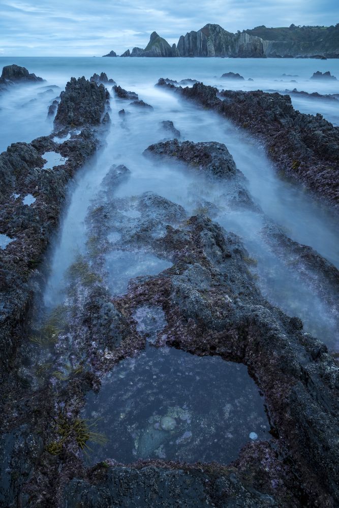 Foggy landscape of Playa de Gueirua rock seashore
