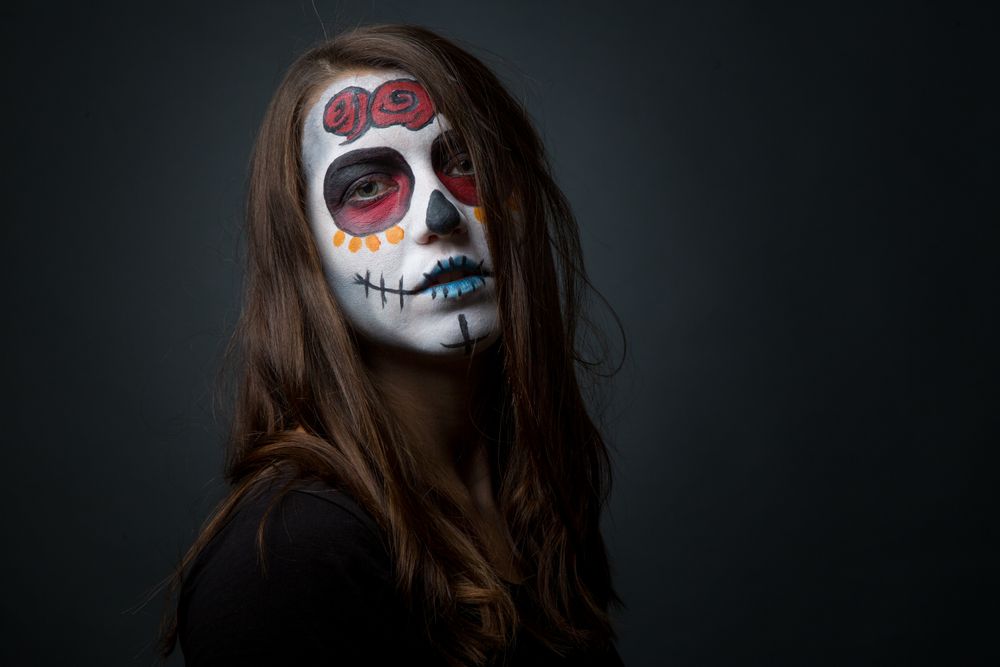 Young woman with creepy face paint