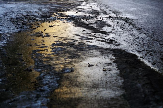 Snowy slush on concrete road in dusk