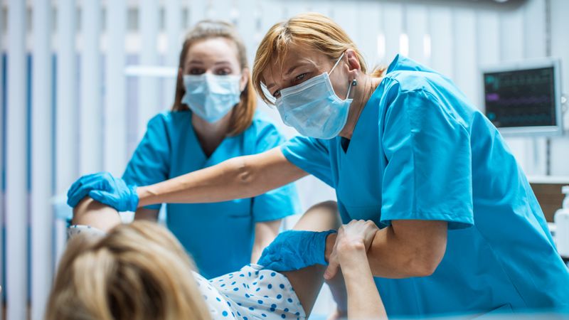 In the Hospital Professional Midwives Helping  Woman in Labor