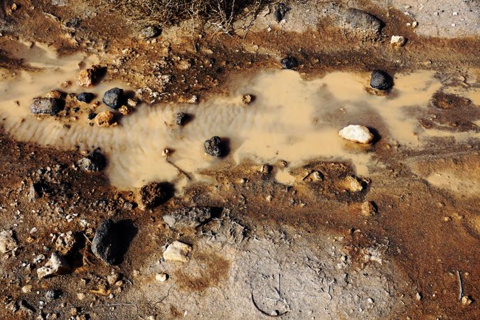 Dirty clay water with rocks