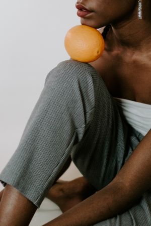 Woman resting her head on an orange