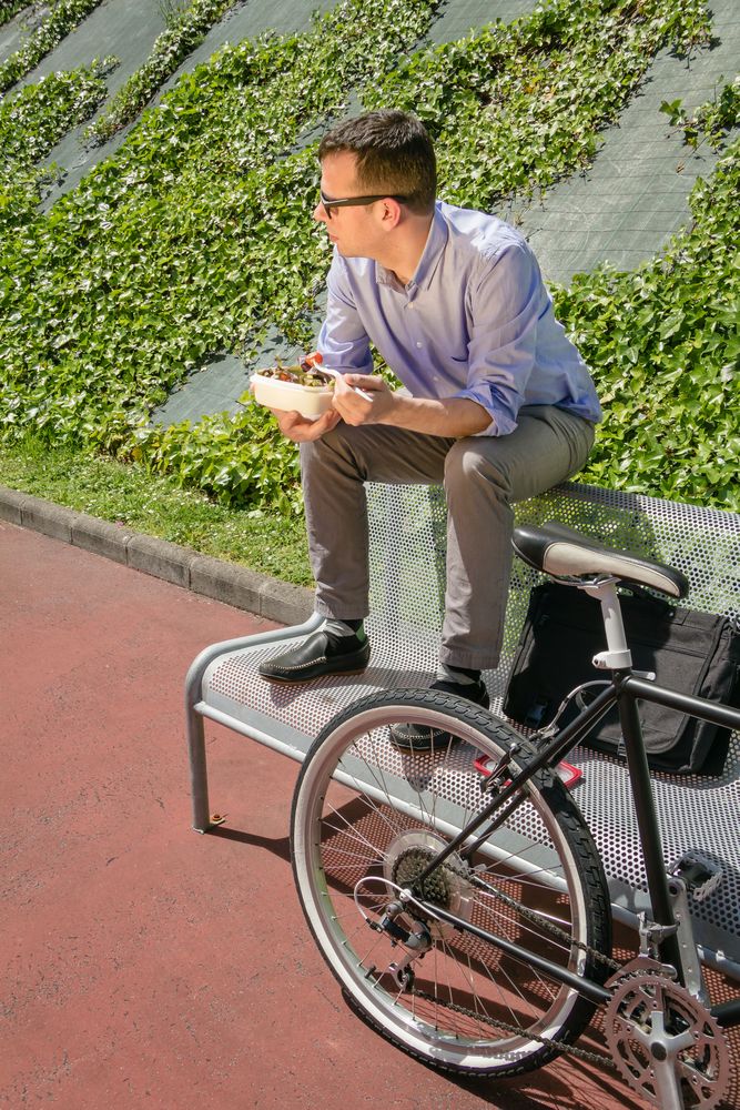 Young business man eating at lunch break outdoors