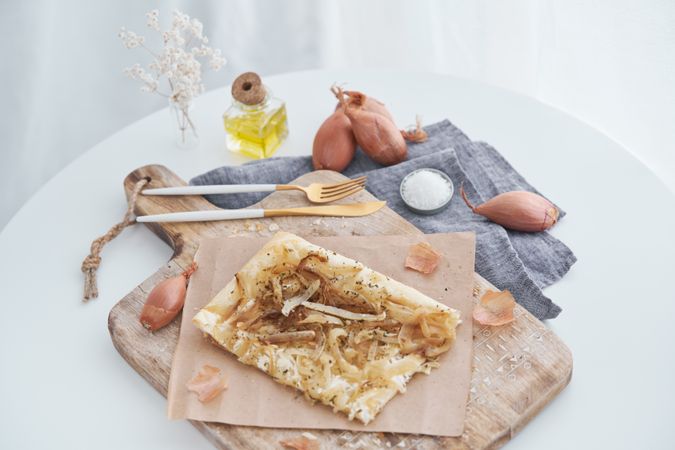 Puff pastry onion tart on chopping board