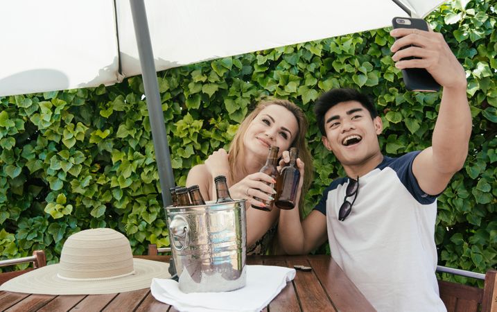 Young couple drinking beer on a sunny day