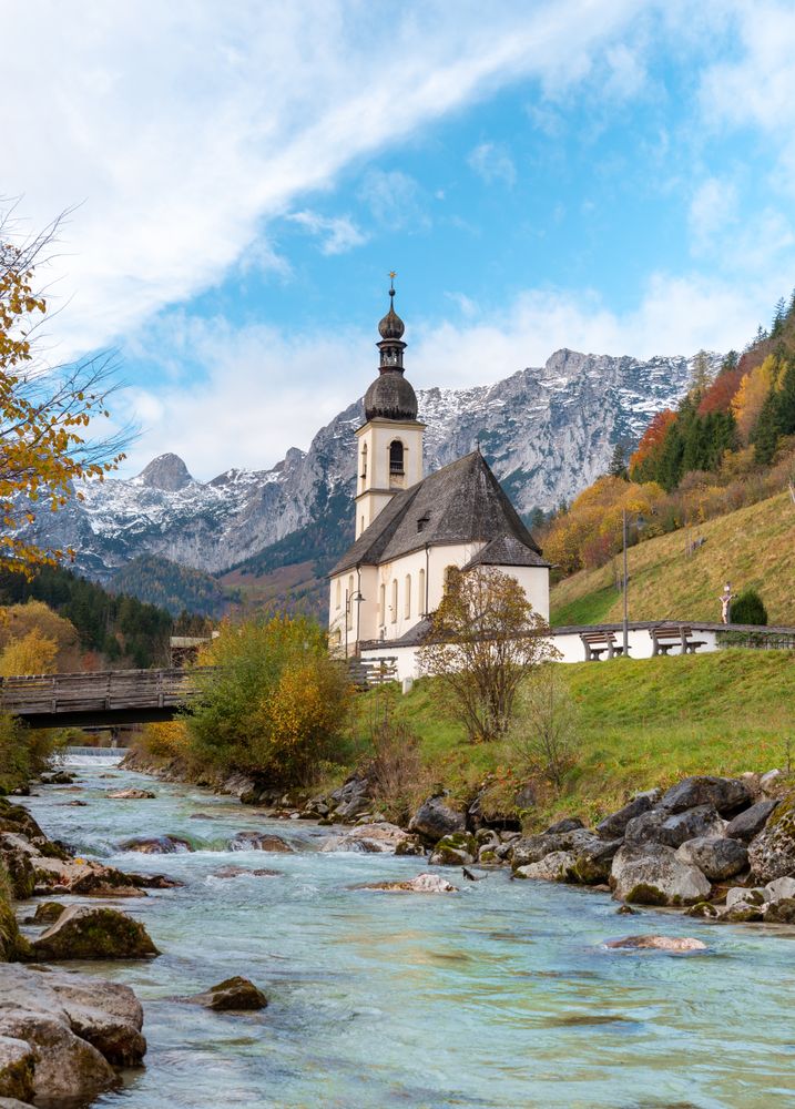 Mountain river and church in an autumn scenery in the Bavarian Alps