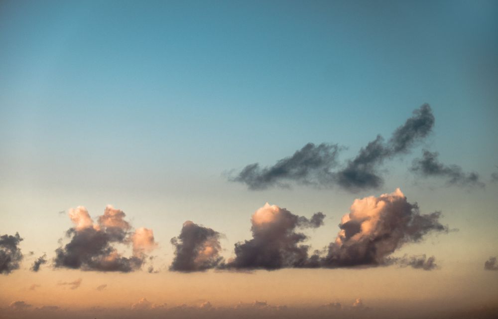 Fluffy clouds in smokey gradient sky