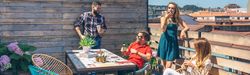 Friends talking and drinking at a party on a terrace