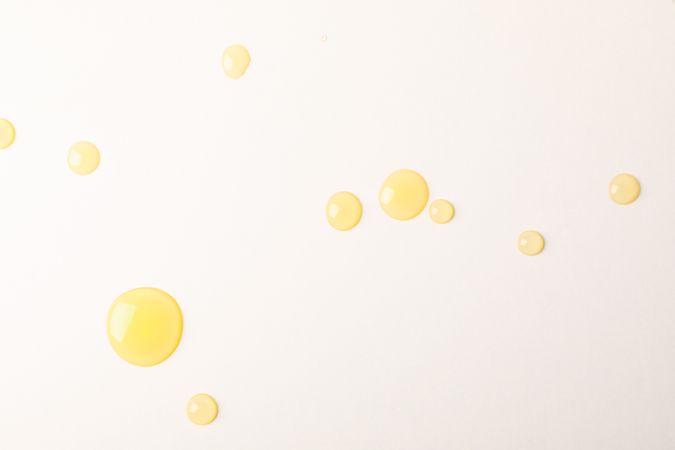 Honey drops on blank background, space for text