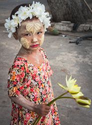 Bagan, Myanmar - June, 25 2012: Little girl with flowers and painted face