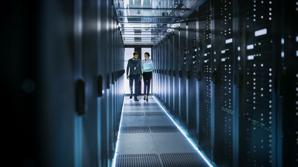 Female IT Technician and Male Server Engineer Talk and Discuss.