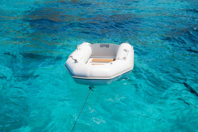 Inflatable boat floating in clear sea