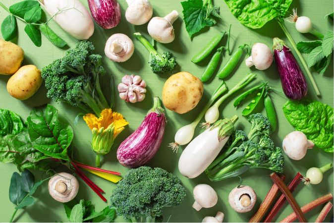 Top view of fresh organic vegetables on green table