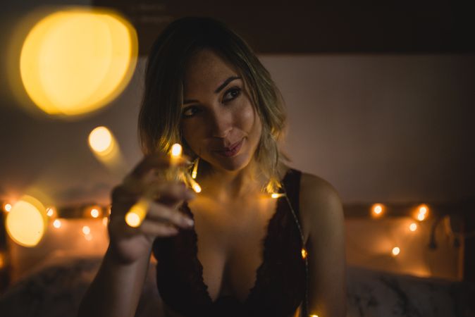 Woman surrounded with light garland