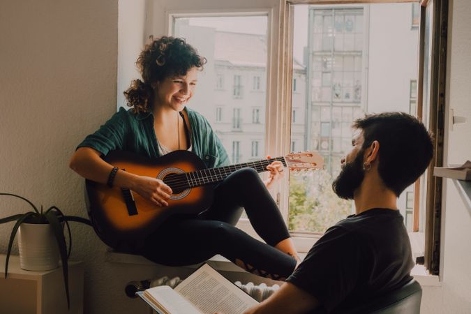 Cheerful couple spending time together at home