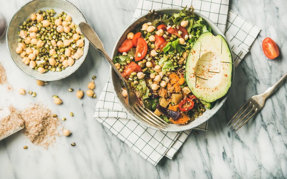 Healthy vegan lunch bowl with avocado, sprouted grains, vegetables,  horizontal composition