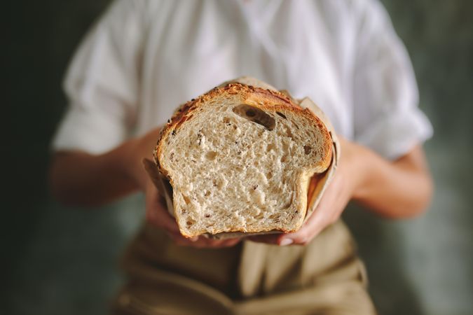 Cropped shot of female baker holding fresh bread