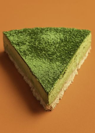 Close up of single matcha cheesecake slice