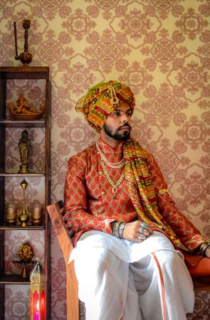 Man wearing turban sitting on chair indoor