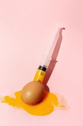 Syringe sucking yolk out of raw egg