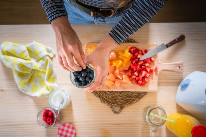 Crop woman preparing healthy food