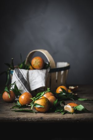 Mandarins and basket on table