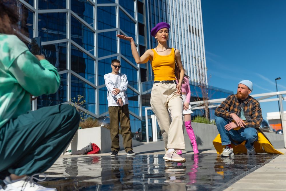 Vibrant Outdoor Scene Capturing A Young Asian Woman Dancing Confidently In A City Plaza