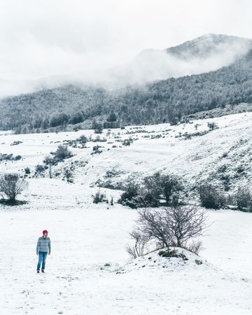 Man walking on winter field