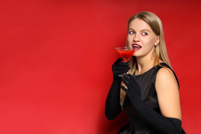 Concept of Halloween, young woman on red background