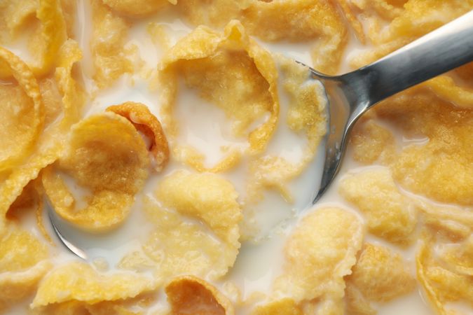 Muesli with milk and spoon, close up