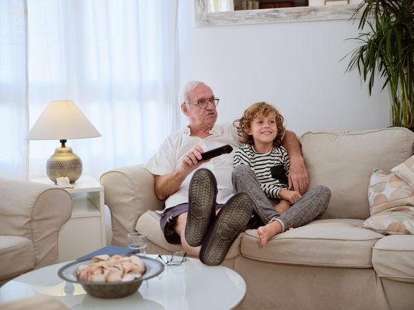 Grandfather with son watching TV