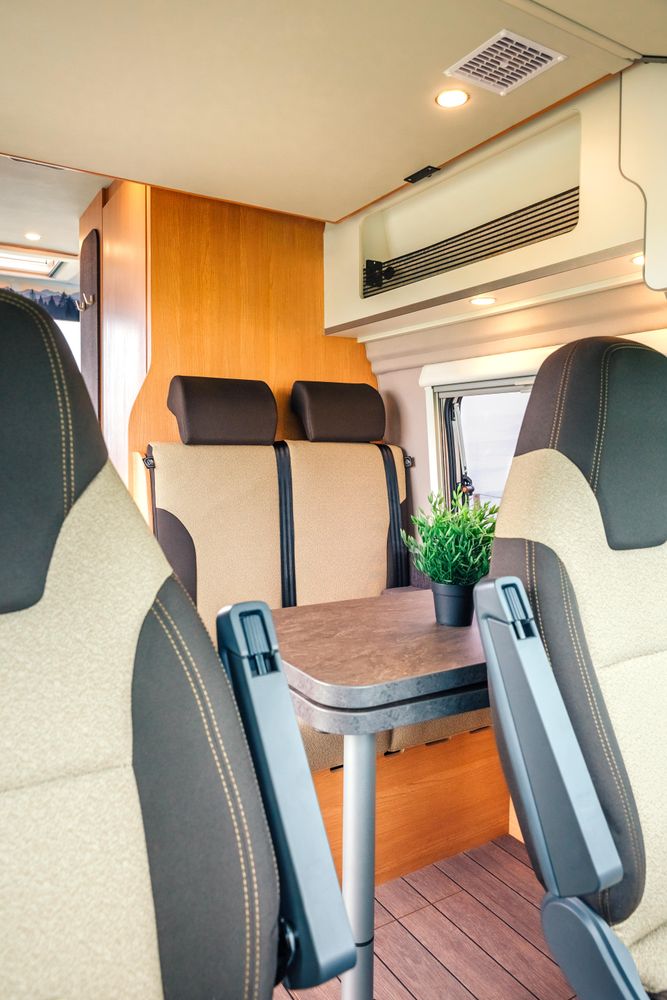 Passenger seats inside of empty motorhome, vertical