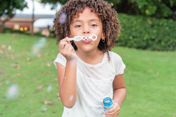 Little girl playing with bubbles