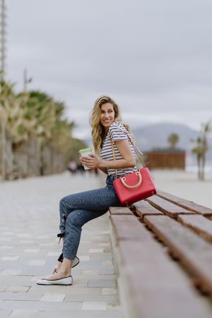 Young woman sitting on bench