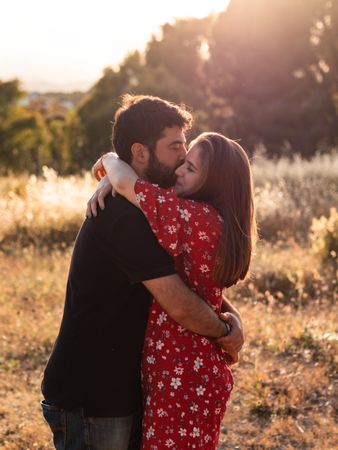 Young happy couple embracing in beautiful garden