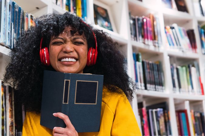 Content female student with book in library