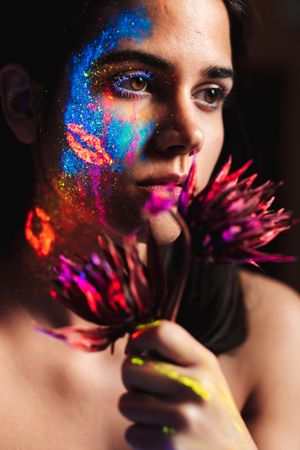 Young woman covered with uv painting