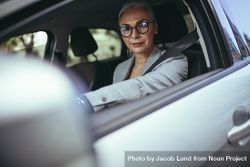Mature woman driver a car looking at camera 5XppM5