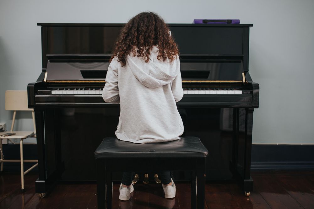 Rear view of student playing guitar