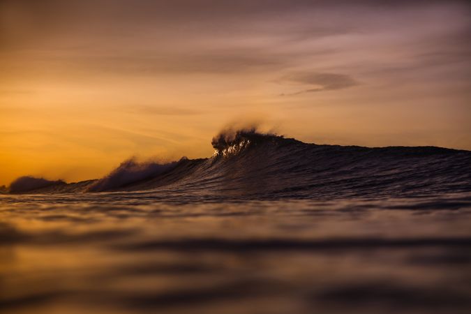 Water wave and cloudy sky
