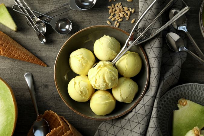 Melon ice cream scoops on a dark background