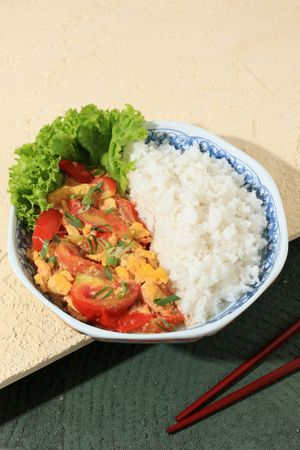 A Plate of Rice with Stir-fried Tomatoes and Scrambled Egg.