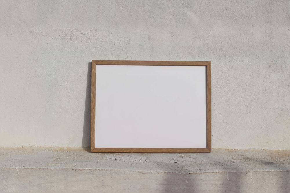 Blank poster frame on sunny outside