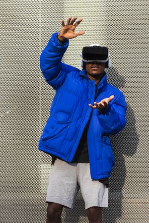 Black man experiencing virtual reality in city
