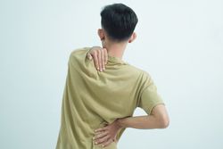 Asian young man feeling pain on his neck