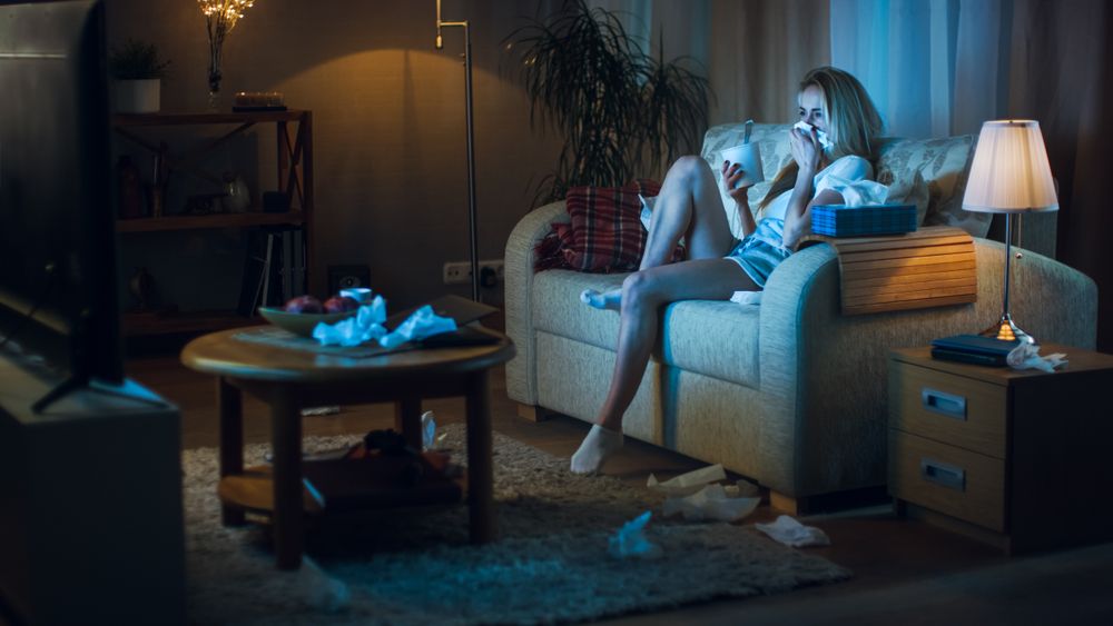 In the Evening Heartbroken Woman Sitting on a Sofa