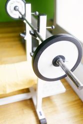 Weights on a bar in the gym, vertical composition