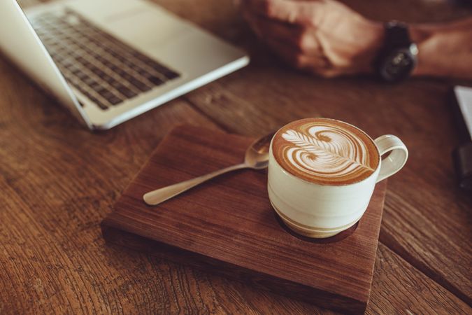 Coffee cup with milk foam art pattern