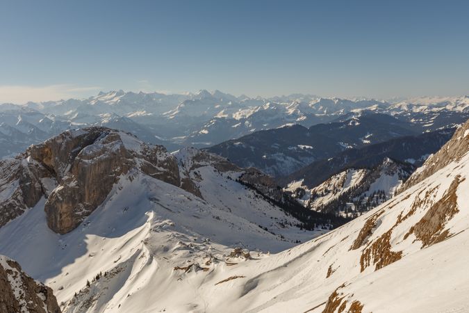 Snowy ski on mountains in sunlight